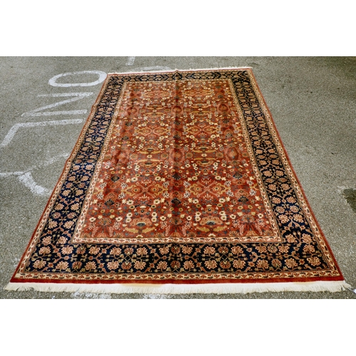 312 - A Persian rug with floral motifs, on a pink ground  77