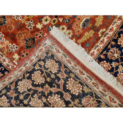 312 - A Persian rug with floral motifs, on a pink ground  77