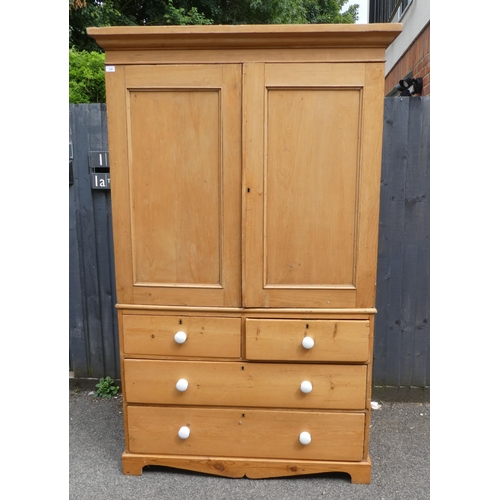 124 - A late Victorian Heal & Son, London pine linen press with a moulded cornice and a pair of panell... 