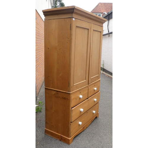 124 - A late Victorian Heal & Son, London pine linen press with a moulded cornice and a pair of panell... 