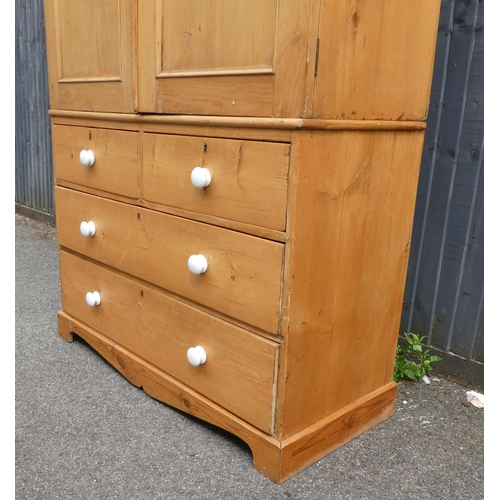 124 - A late Victorian Heal & Son, London pine linen press with a moulded cornice and a pair of panell... 