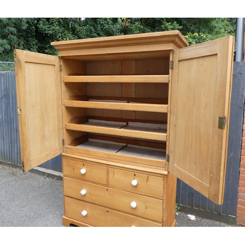 124 - A late Victorian Heal & Son, London pine linen press with a moulded cornice and a pair of panell... 