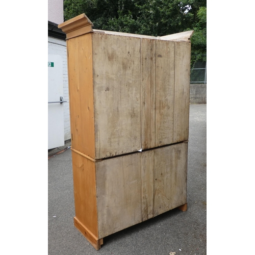 124 - A late Victorian Heal & Son, London pine linen press with a moulded cornice and a pair of panell... 