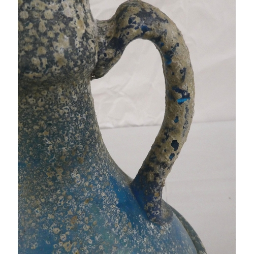 128 - An 'antique' finished, blue glass ewer  13.5