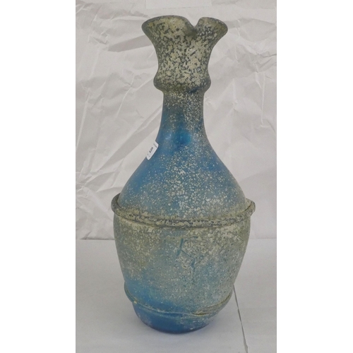 128 - An 'antique' finished, blue glass ewer  13.5