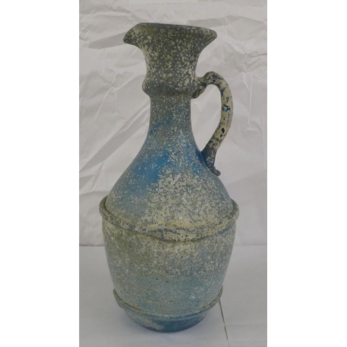 128 - An 'antique' finished, blue glass ewer  13.5