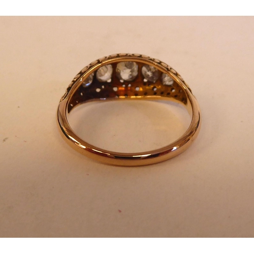 149 - A Victorian gold and black enamel, blue diamond ring, set with five graduated stones, on scrolled sh... 