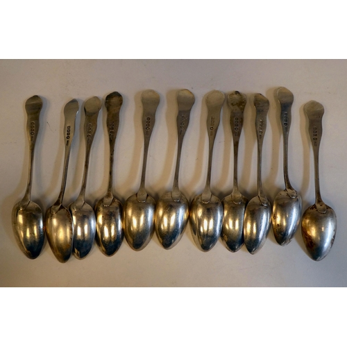 150 - A set of eleven Victorian Scottish silver dessert spoons with ornately cast, scrolled and chased ter... 