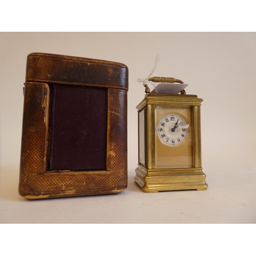 152 - An early 20thC lacquered brass cased miniature carriage timepiece with bevelled glass panels and a f... 