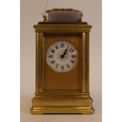 152 - An early 20thC lacquered brass cased miniature carriage timepiece with bevelled glass panels and a f... 