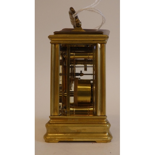 152 - An early 20thC lacquered brass cased miniature carriage timepiece with bevelled glass panels and a f... 