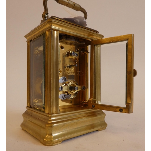 152 - An early 20thC lacquered brass cased miniature carriage timepiece with bevelled glass panels and a f... 