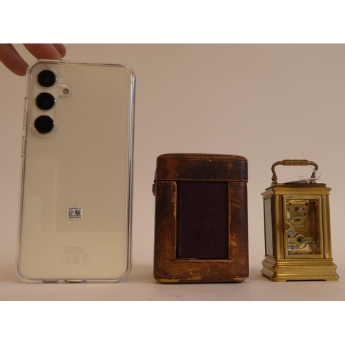 152 - An early 20thC lacquered brass cased miniature carriage timepiece with bevelled glass panels and a f... 