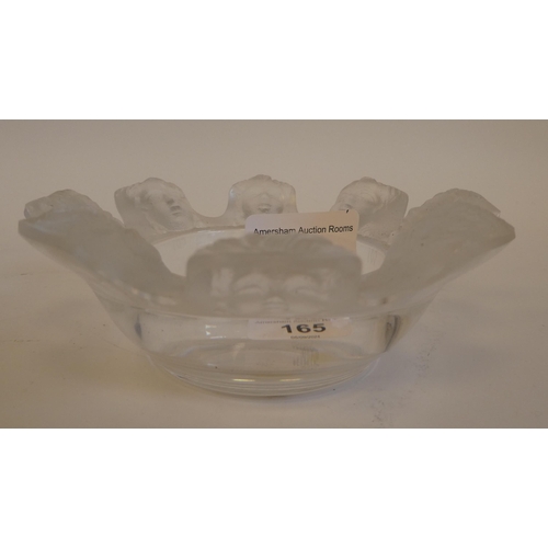 165 - A Lalique part-frosted crystal ashtray 'St Nicholas' with eight cherubic faces  bears an etched... 