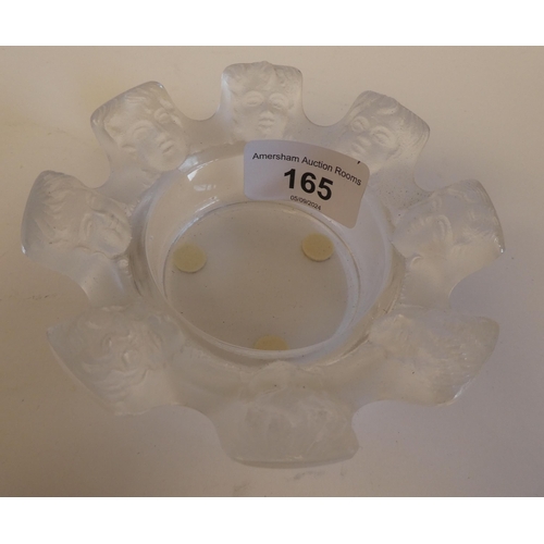 165 - A Lalique part-frosted crystal ashtray 'St Nicholas' with eight cherubic faces  bears an etched... 