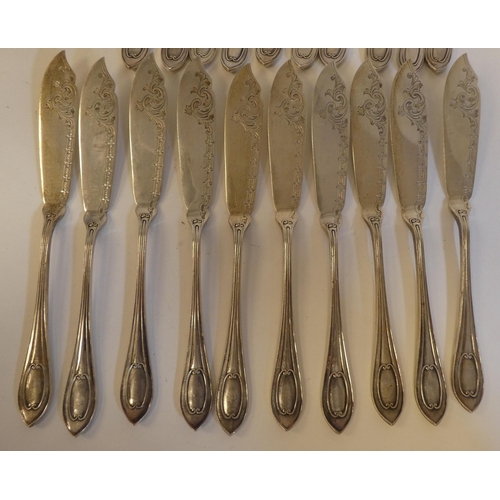 166 - A set of ten silver fish knives and forks with engraved blades and C-scrolled handles  Walker &... 