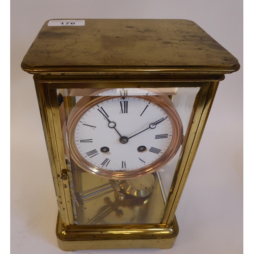 176 - A mid 20thC lacquered brass cased, four glass mantel clock with bevelled panels and a platform top, ... 