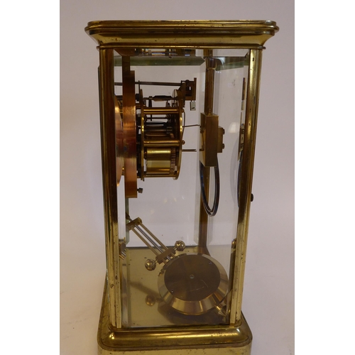 176 - A mid 20thC lacquered brass cased, four glass mantel clock with bevelled panels and a platform top, ... 