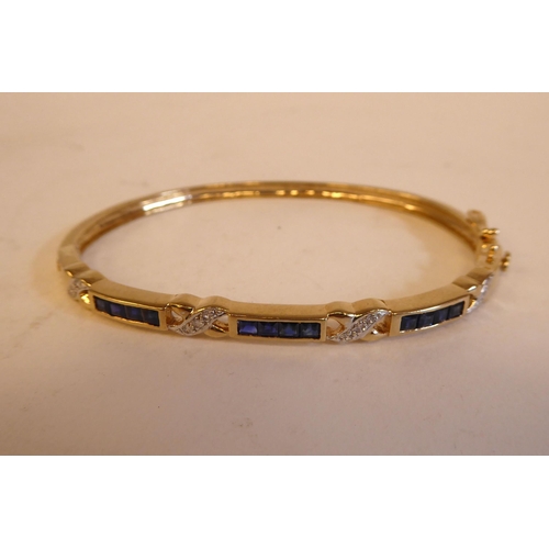 186 - A 9ct gold sapphire and diamond set, hinged bangle