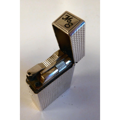 188 - A Dupont gas filled cigarette lighter in textured white metal  impressed IK 2FR23  boxed with certif... 