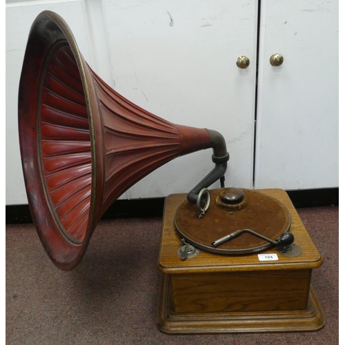 194 - A vintage Edison Bell light oak cased tabletop, wind-up gramophone with a speed regulator, a maroon ... 