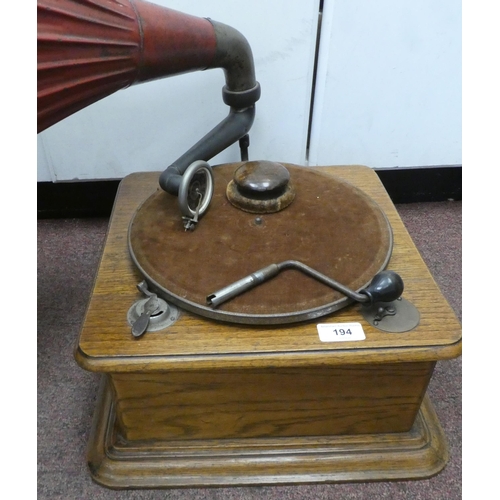 194 - A vintage Edison Bell light oak cased tabletop, wind-up gramophone with a speed regulator, a maroon ... 