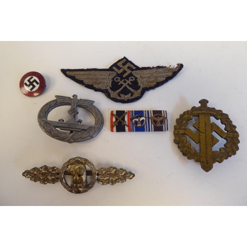 209 - Six World War II German metal and cloth badges and insignia: to include a U Boat badge(Please Note: ... 