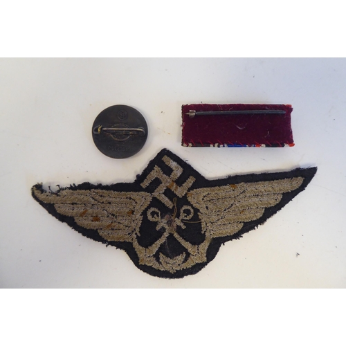 209 - Six World War II German metal and cloth badges and insignia: to include a U Boat badge(Please Note: ... 