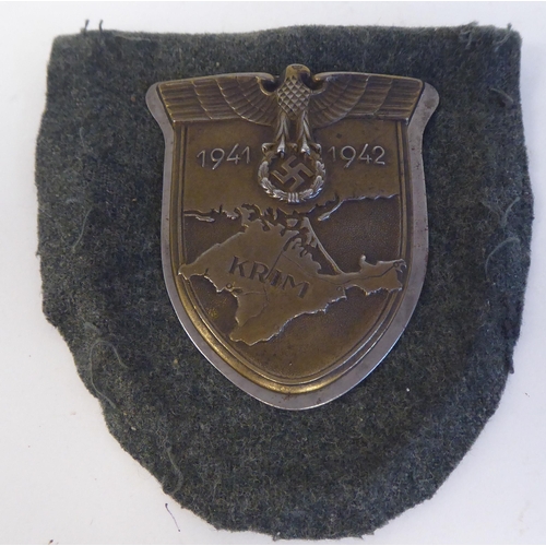 210 - A World War II German cast metal KRIM (Crimea) shield(Please Note: this lot is subject to the statem... 