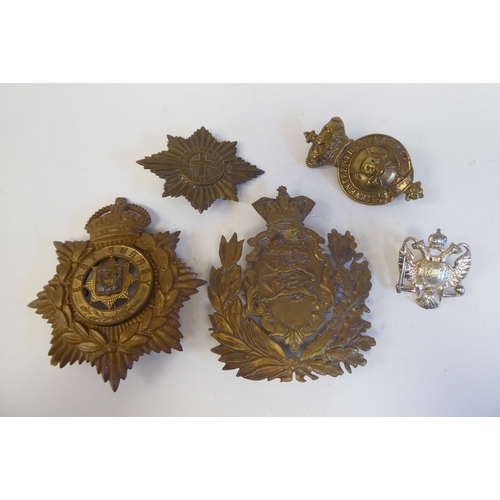 214 - Five military cap badges, some copies: to include a metal example for East Surrey(Please Note: this ... 