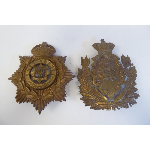 214 - Five military cap badges, some copies: to include a metal example for East Surrey(Please Note: this ... 