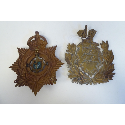 214 - Five military cap badges, some copies: to include a metal example for East Surrey(Please Note: this ... 