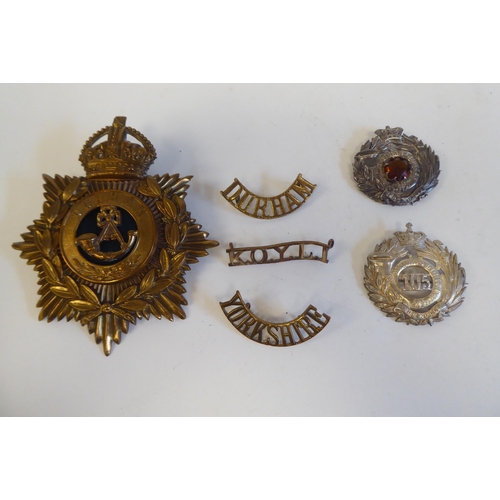 216 - Eleven military Light Infantry metal badges, some copies; and a Durham light Infantry metal helmet p... 