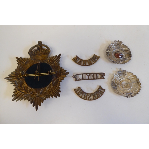 216 - Eleven military Light Infantry metal badges, some copies; and a Durham light Infantry metal helmet p... 