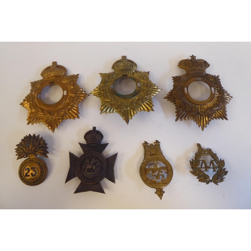 219 - Seven military metal helmet plates and badges, some copies: to include The Welsh Regiment Cyclists(P... 