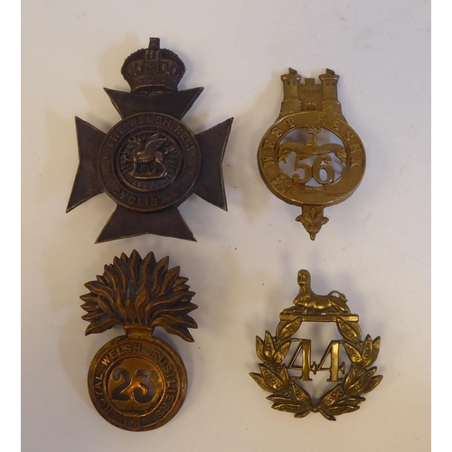 219 - Seven military metal helmet plates and badges, some copies: to include The Welsh Regiment Cyclists(P... 