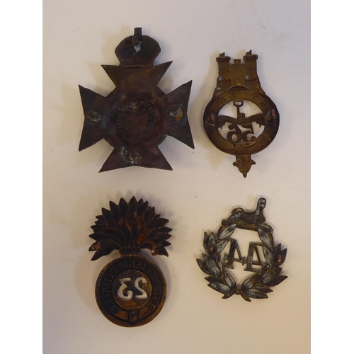 219 - Seven military metal helmet plates and badges, some copies: to include The Welsh Regiment Cyclists(P... 