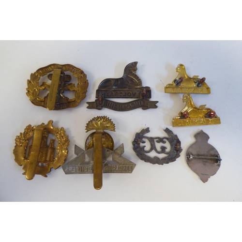 220 - Approximately twenty-five military metal helmet plates and badges, some copies: to include Indian Ar... 