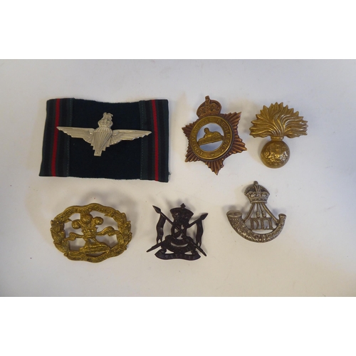 220 - Approximately twenty-five military metal helmet plates and badges, some copies: to include Indian Ar... 