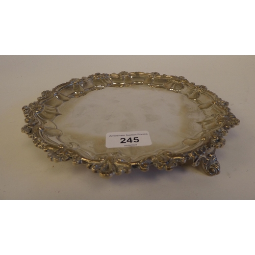 245 - A George IV silver salver with a C-scroll piecrust border, on three feet  London 1820  8.2... 