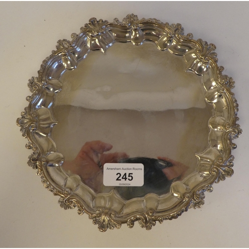 245 - A George IV silver salver with a C-scroll piecrust border, on three feet  London 1820  8.2... 