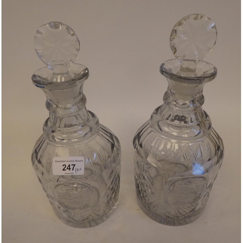 247 - A pair of late Victorian glass decanters with thumb moulded, diamond pattern and armorial cartouches... 