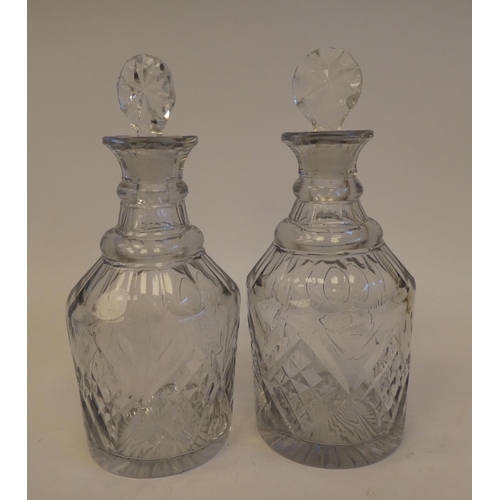 247 - A pair of late Victorian glass decanters with thumb moulded, diamond pattern and armorial cartouches... 