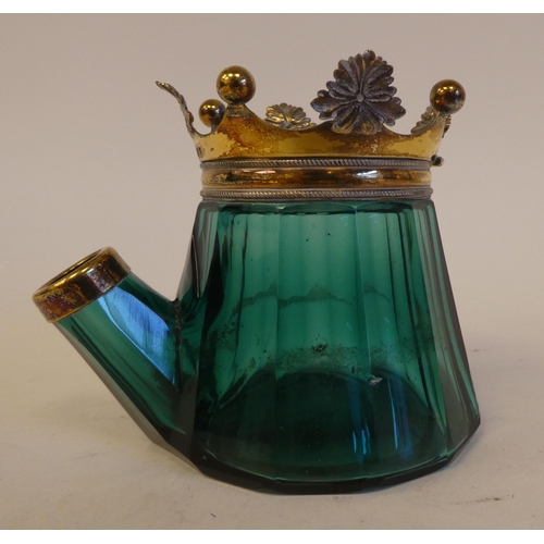 251 - An early Victorian jug shaped bevelled green glass inkwell with a silver gilt mount in the form of a... 