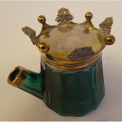 251 - An early Victorian jug shaped bevelled green glass inkwell with a silver gilt mount in the form of a... 