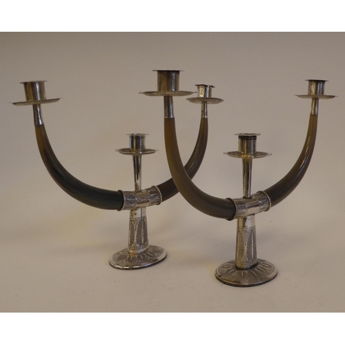 259 - A pair of Malaysian white metal mounted and horn, twin branch pedestal candelabra  bears impressed m... 