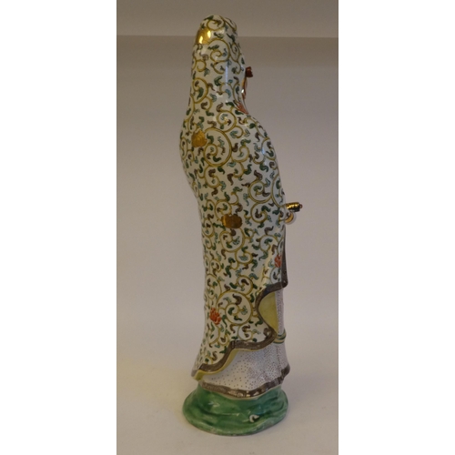 264 - An early 20thC Japanese porcelain figure 'Goddess Kannon' wearing multi-coloured and gilded robes  2... 