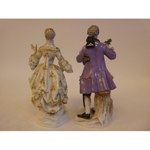 265 - A pair of mid 19thC Meissen porcelain figures, viz. a woman wearing a ballgown, holding a fan  impre... 