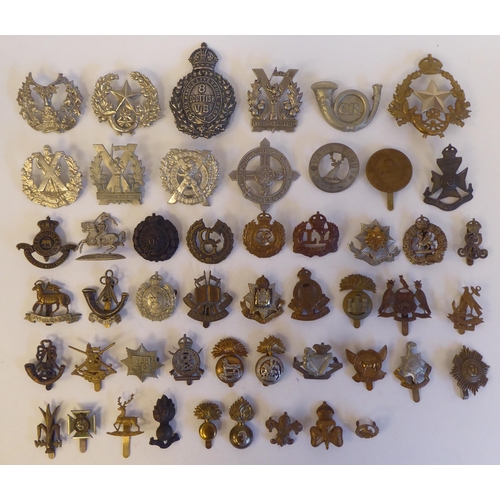 269 - Approximately fifty military metal cap badges, some copies: to include 'The Kings Liverpool Regiment... 