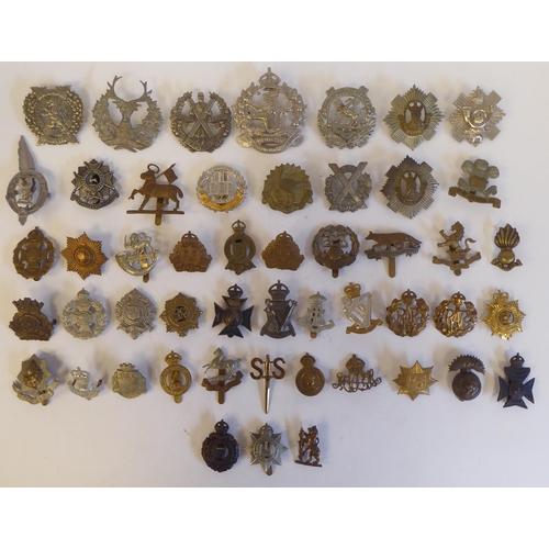 271 - Approximately fifty military metal cap badges, some copies: to include 'Cheshire Regiment'(Please No... 